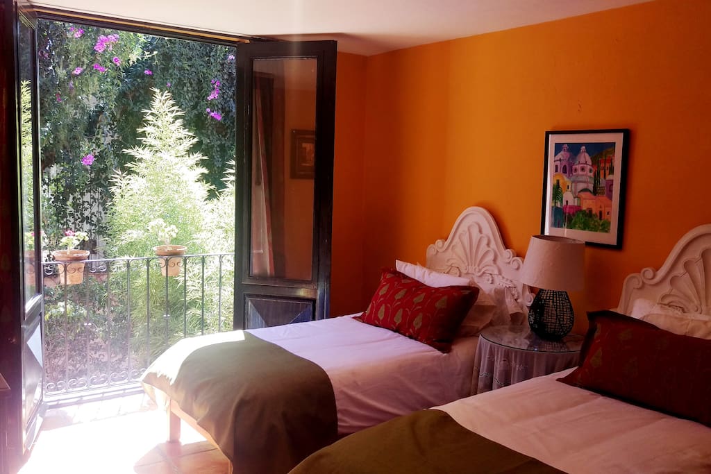 A sunny guest room with an adjacent private bath