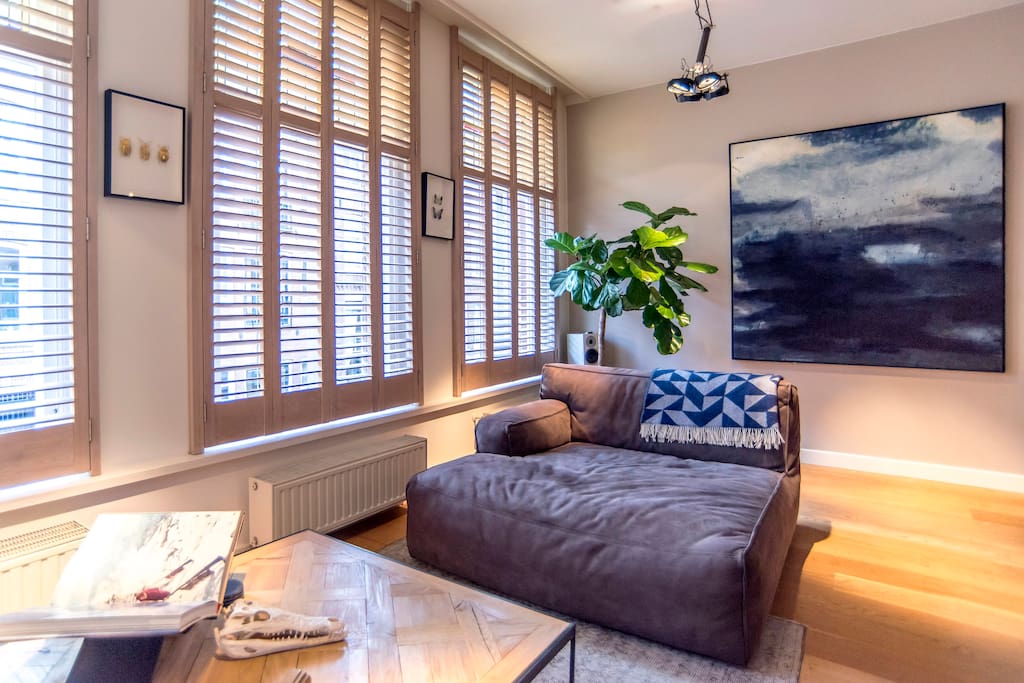White wash oak shutters which can be closed at night or completed opened during the day.