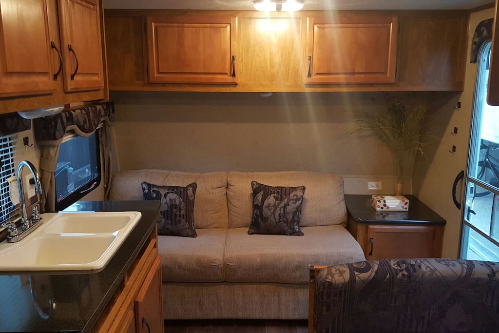 Couch sleeper, table for 4 (also a bed) and kitchen sink