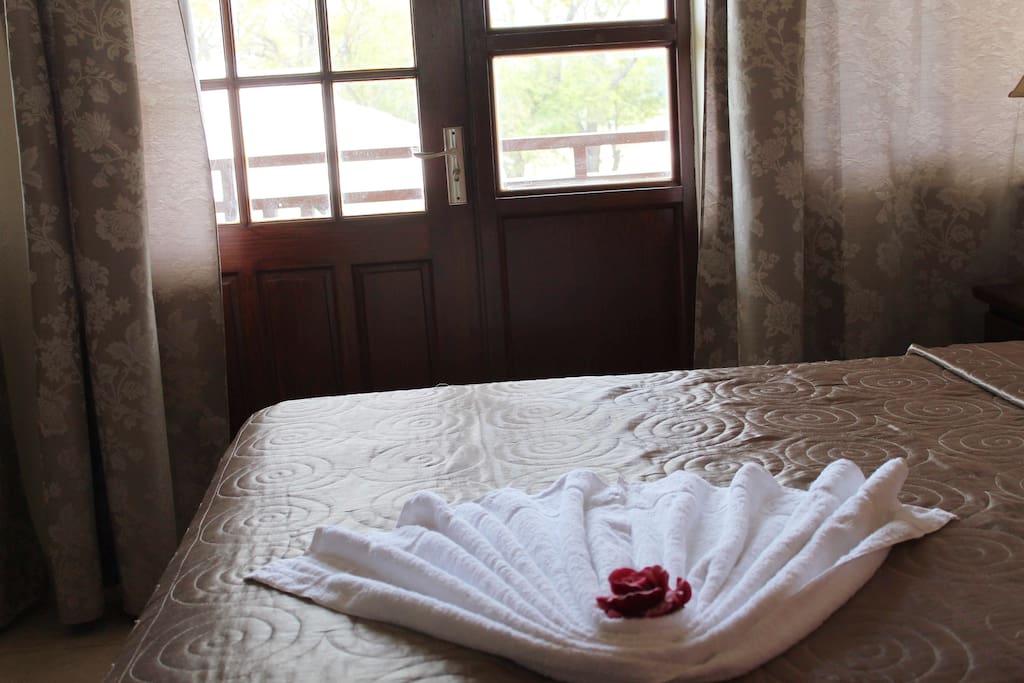 Comfortable Queen sized bed with a view of the patio.