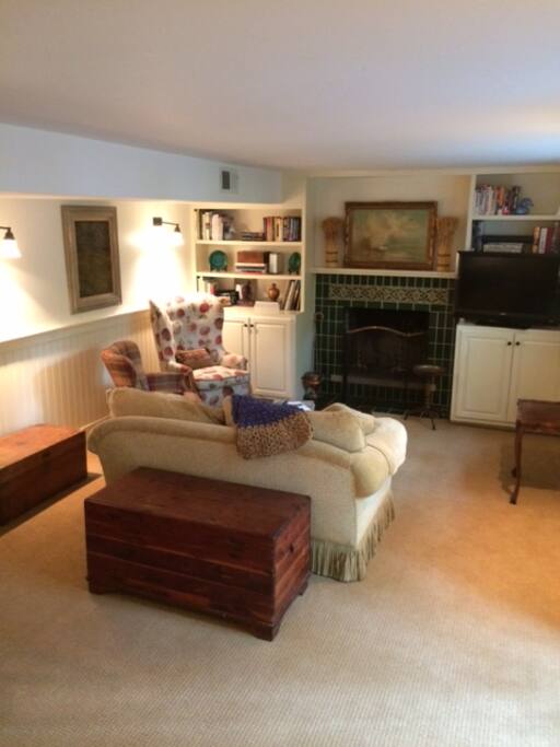 Living room with fireplace and french doors to garden.
