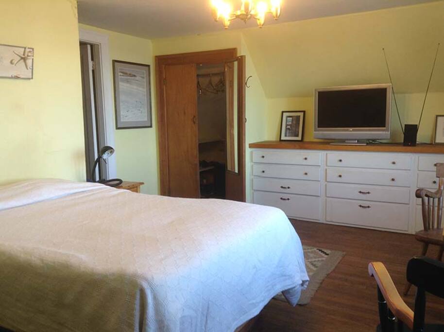 Plenty of storage space and a place to watch TV. The wall color has changed to a muted rose.