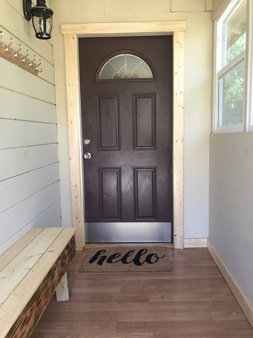 Entrance mud room with bench and coat hooks