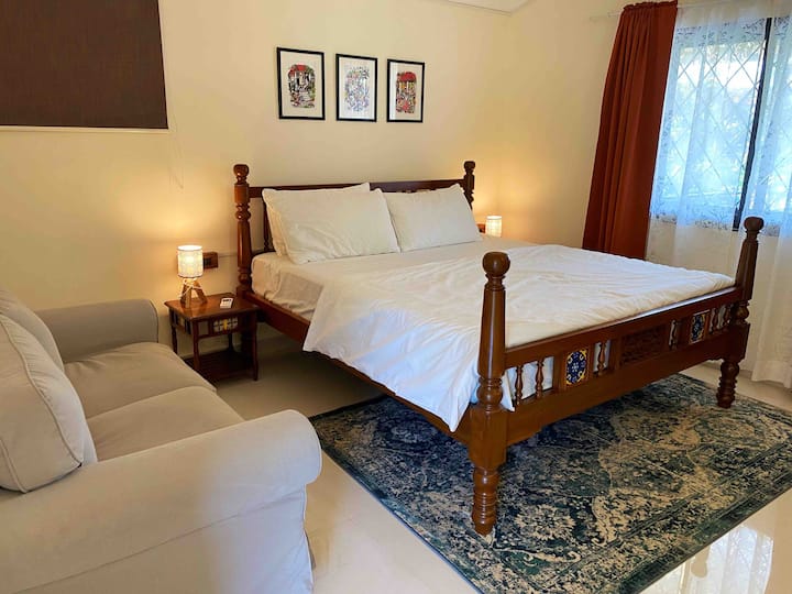 Bedroom two on the first floor has an attached balcony facing the jungles. It is spacious and has a comfortable king size bed, a couch and a study table for both relaxation as well as workation