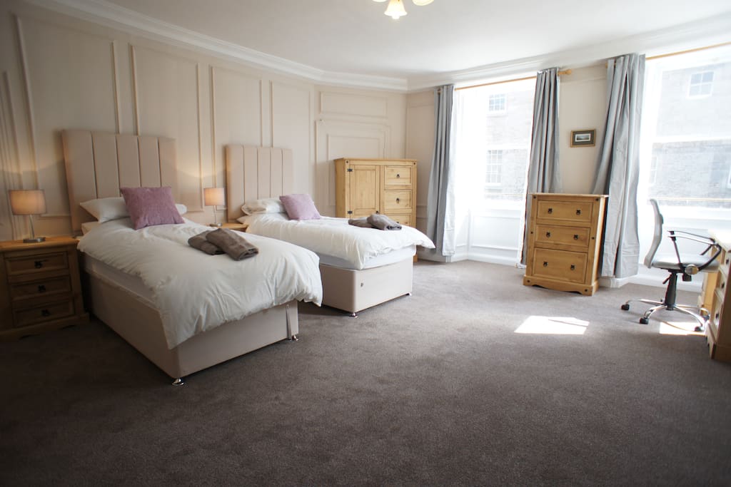 Spacious twin bedroom with work station