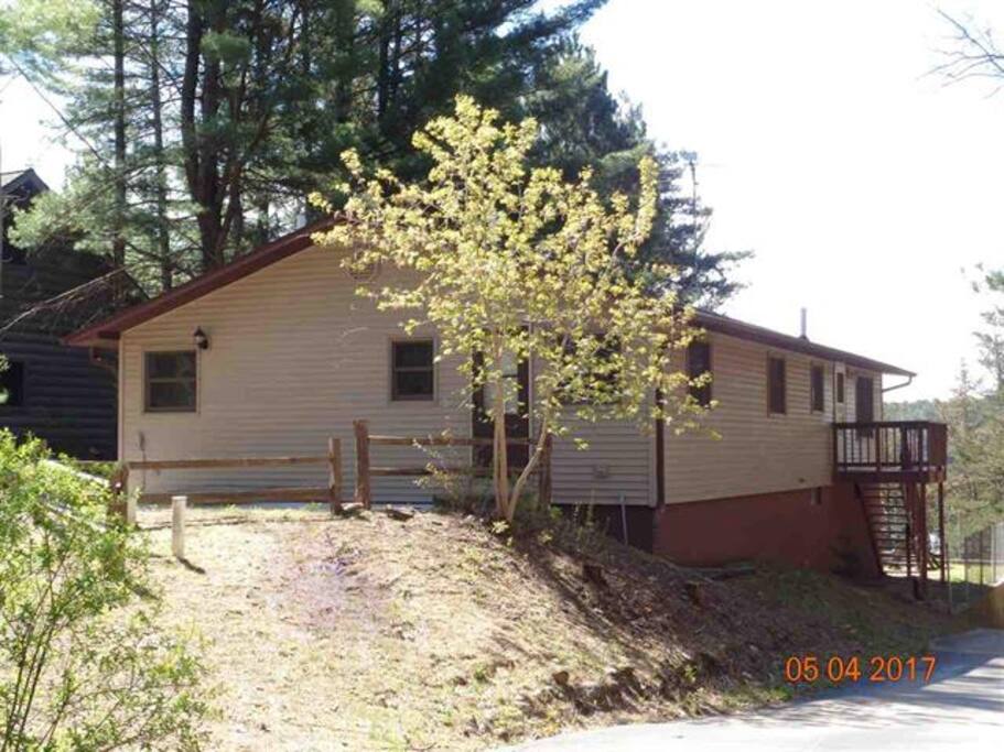Exterior of our cabin on round lake just steps from a beautiful beach -- two car parking available right out front of the cabin.