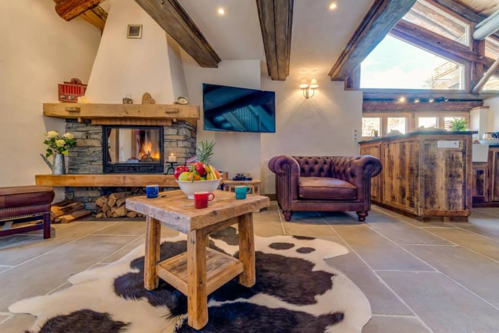 Wall mounted TV and a modern wood burning fire