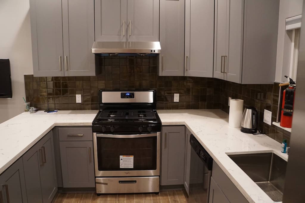 New kitchen has microwave, water boiler, full stove, oven and fully stocked eating and cooking utensils