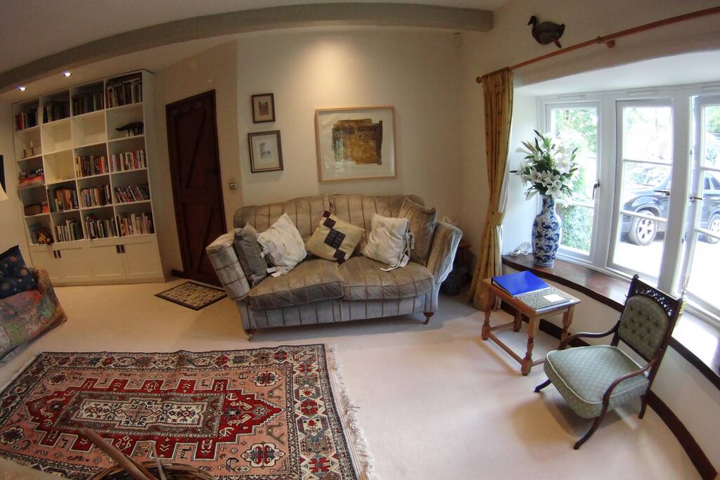 Spacious reception and living room area, with books, games and DVDs