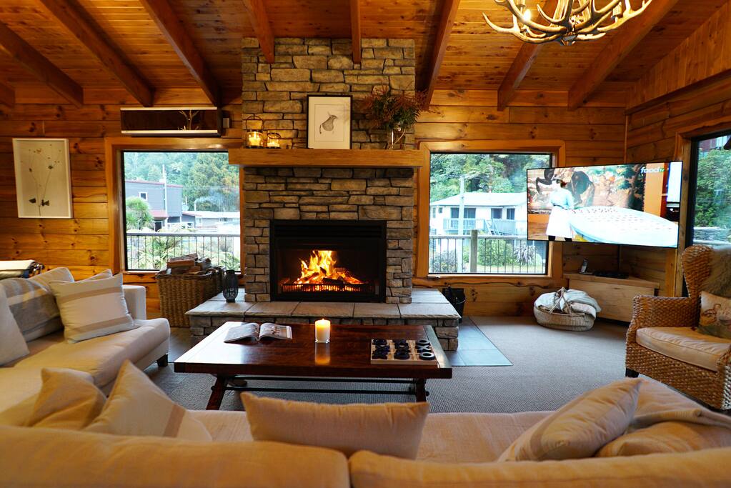 Lounge with open stone fire and 65" TV with SKY and sound system