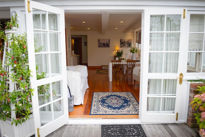 Closer view of the open apartment from small wooden deck