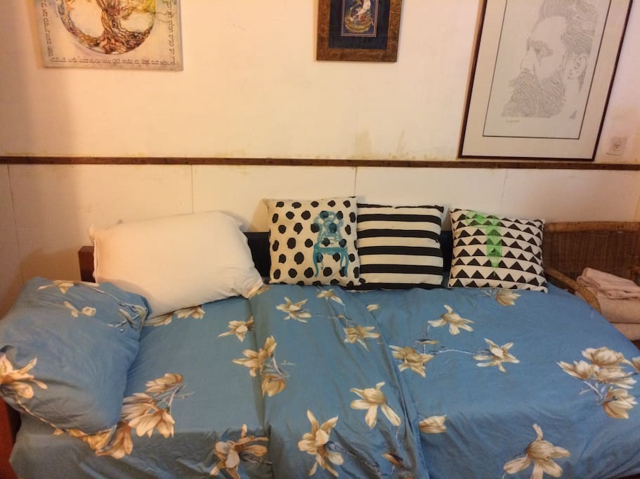 The bed with lots of pillows, and extra foam mattress