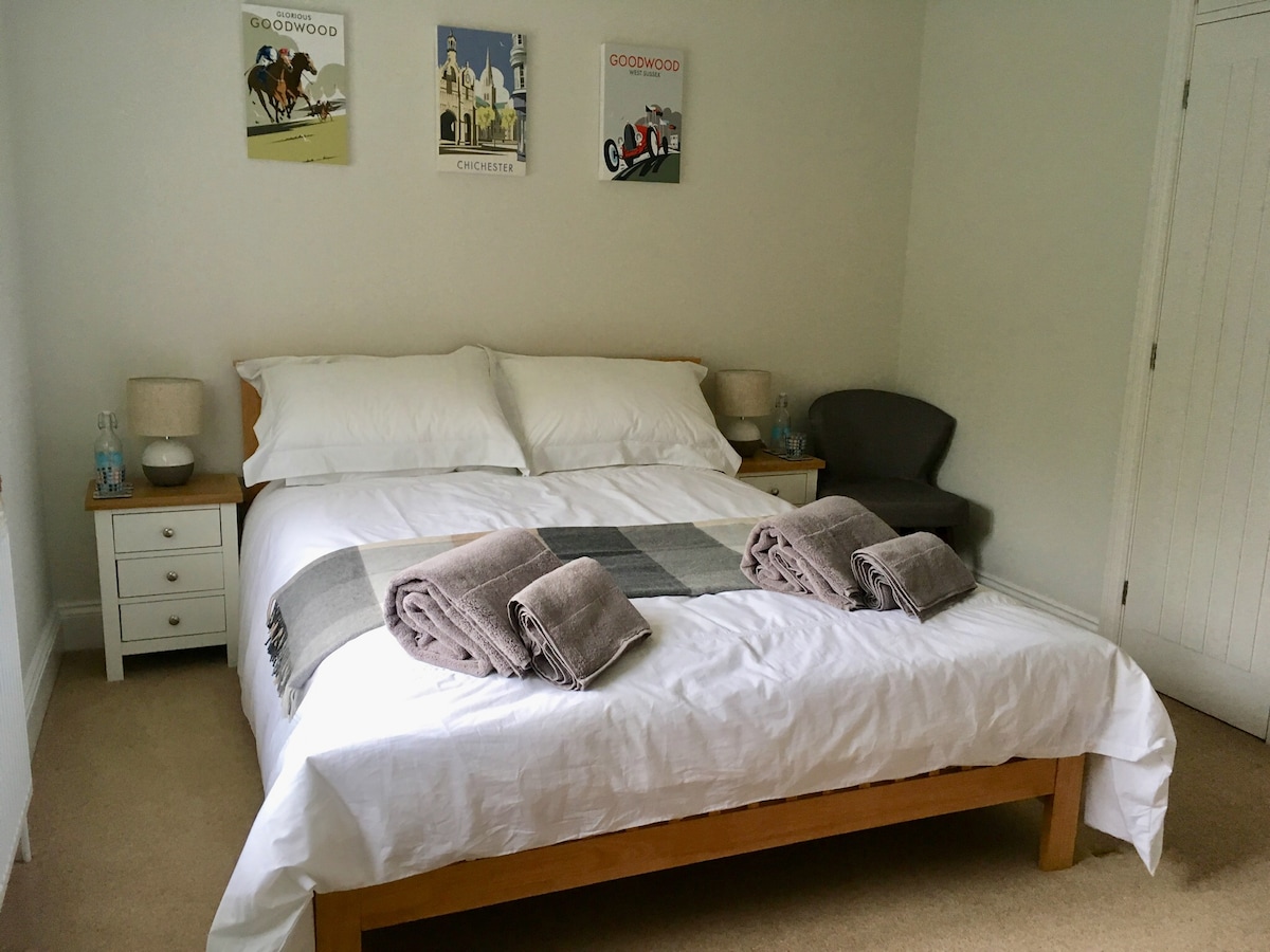 Luxusná manželská posteľ. Biela posteľná bielizeň a uteráky