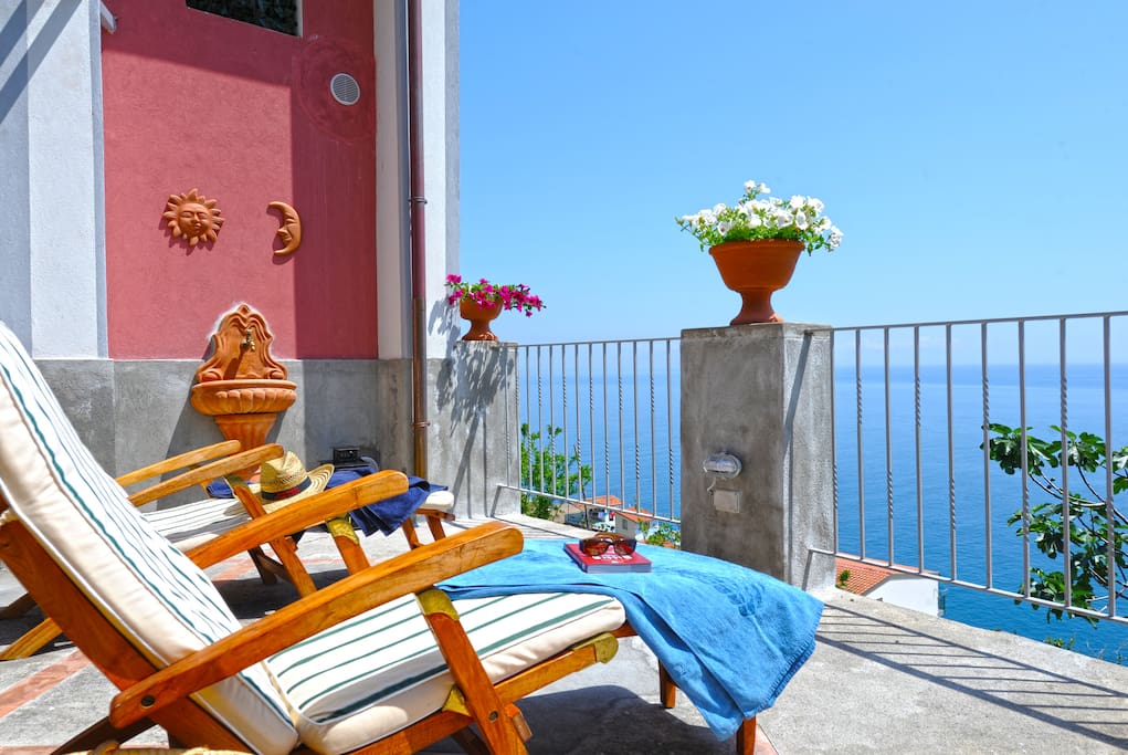 Large terrace with sun beds in wood with sea view