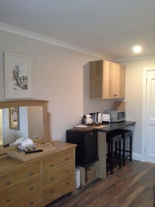 Compact kitchenette area, with bar-stool seating.