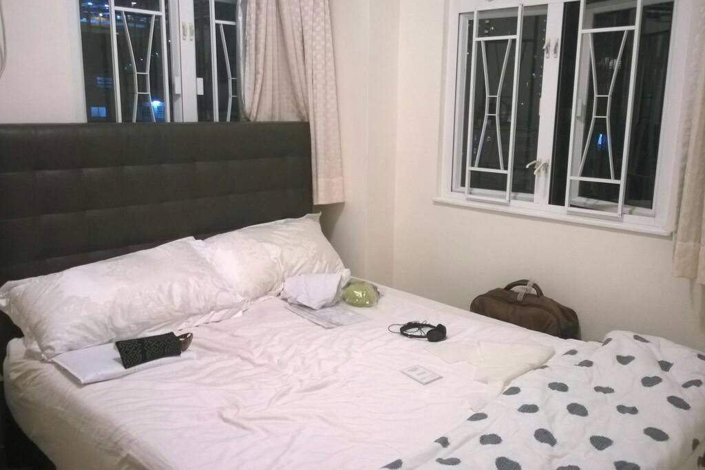 Queen size bed with two windows, nice sunlights come through.