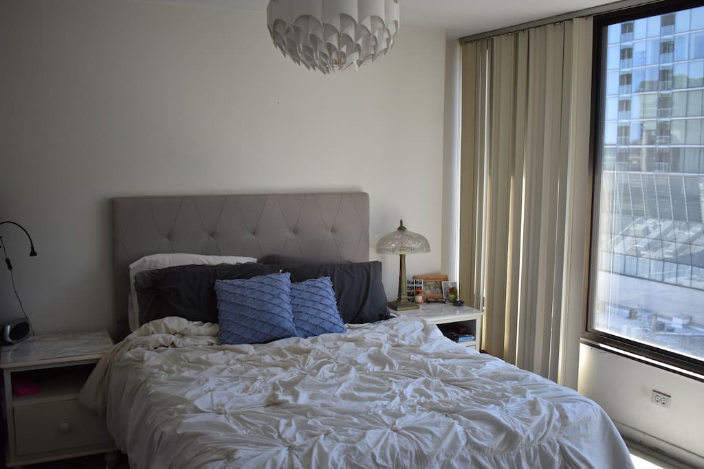 Master bedroom: queen memory foam bed, floor to ceiling windows and blinds, beautiful views of downtown Chicago