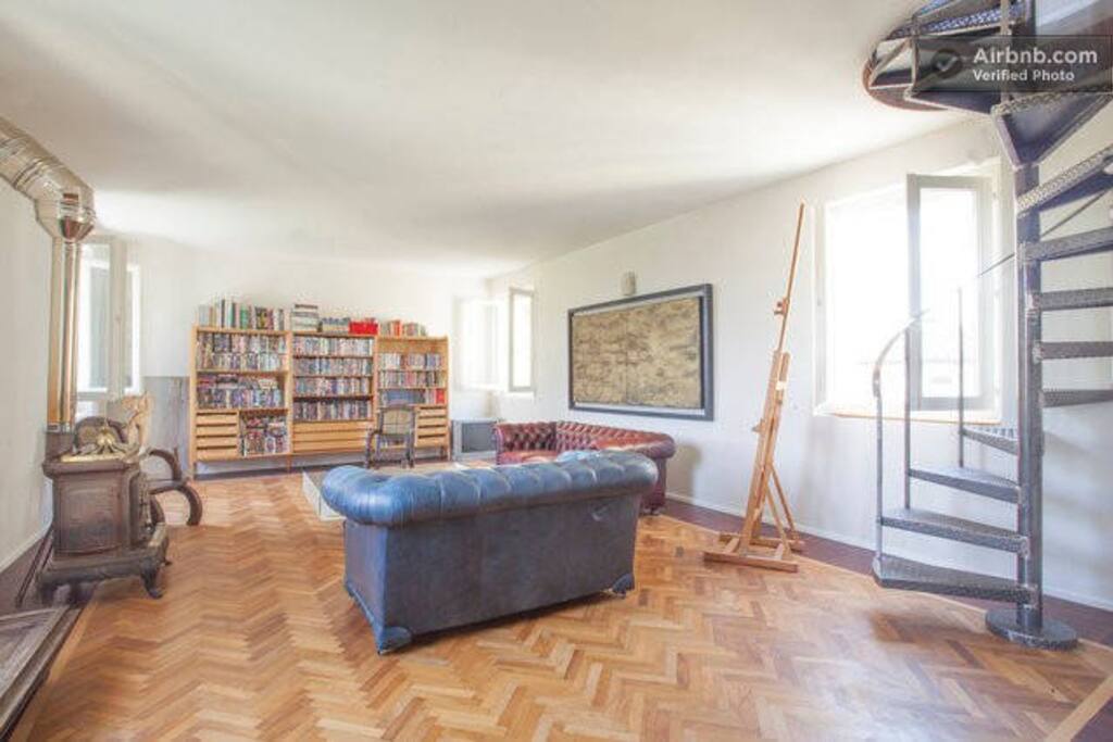 Living room on 1st floor with stairs leading to loft