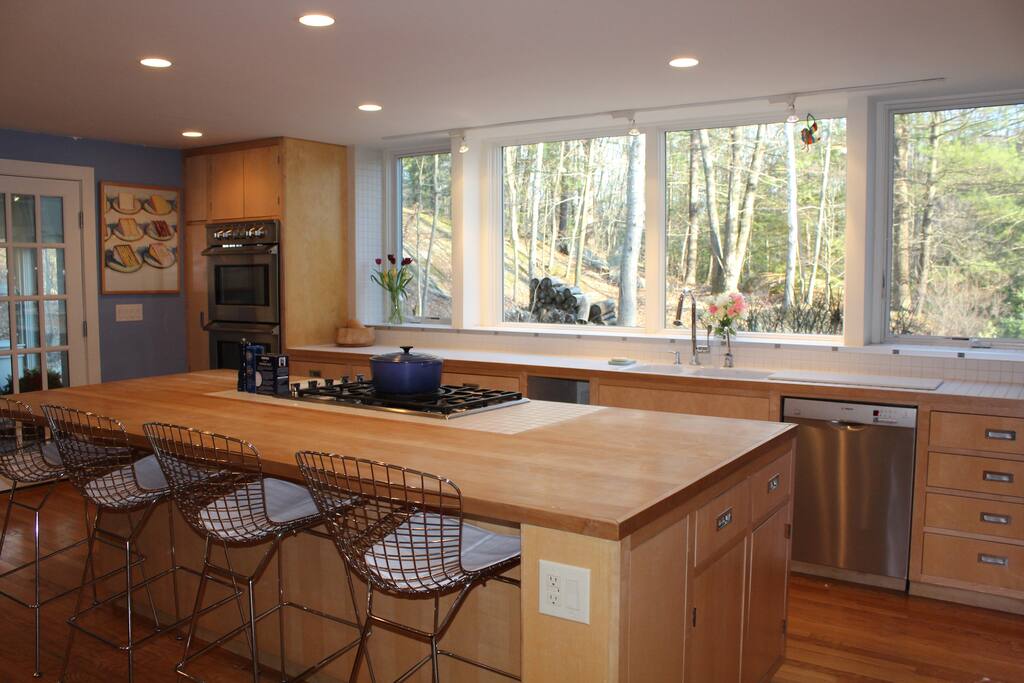 Chef's kitchen with gas range, double oven, dishwasher, microwave, nespresso machine, toaster, and a huge butcher block island. Great windows, views, light.