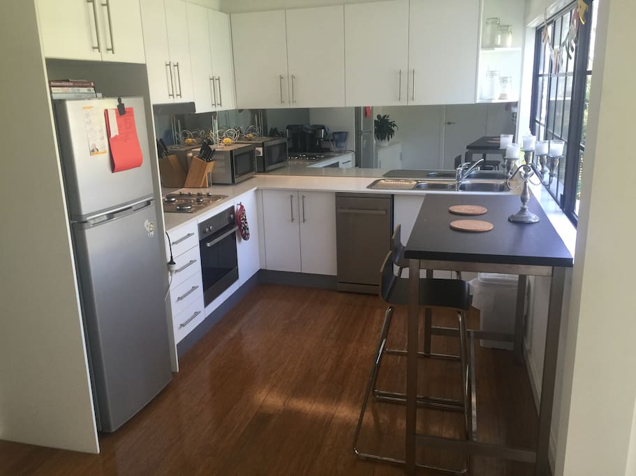Kitchen with modern fridge, gas stove and dishwasher