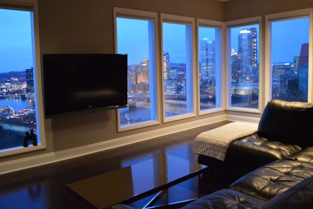 Walls of windows allow you to watch the city buzz from the comfort of your couch.