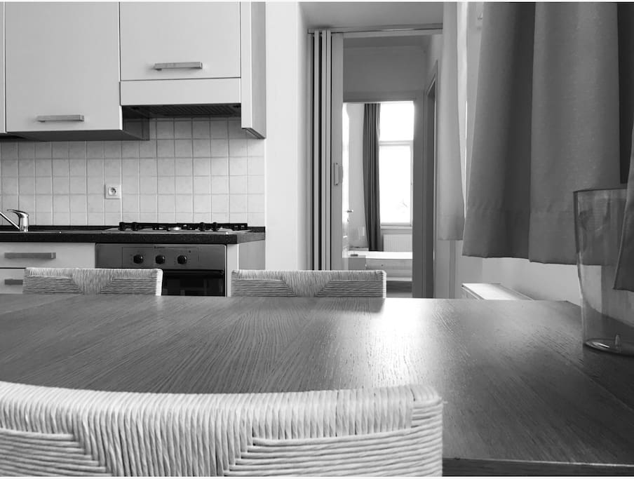 This is the second room where there is a dining table. You can see the corridor that leads up to the inner bedroom from here. There is a door to the inner bedroom and the corridor that can be shut when required.
