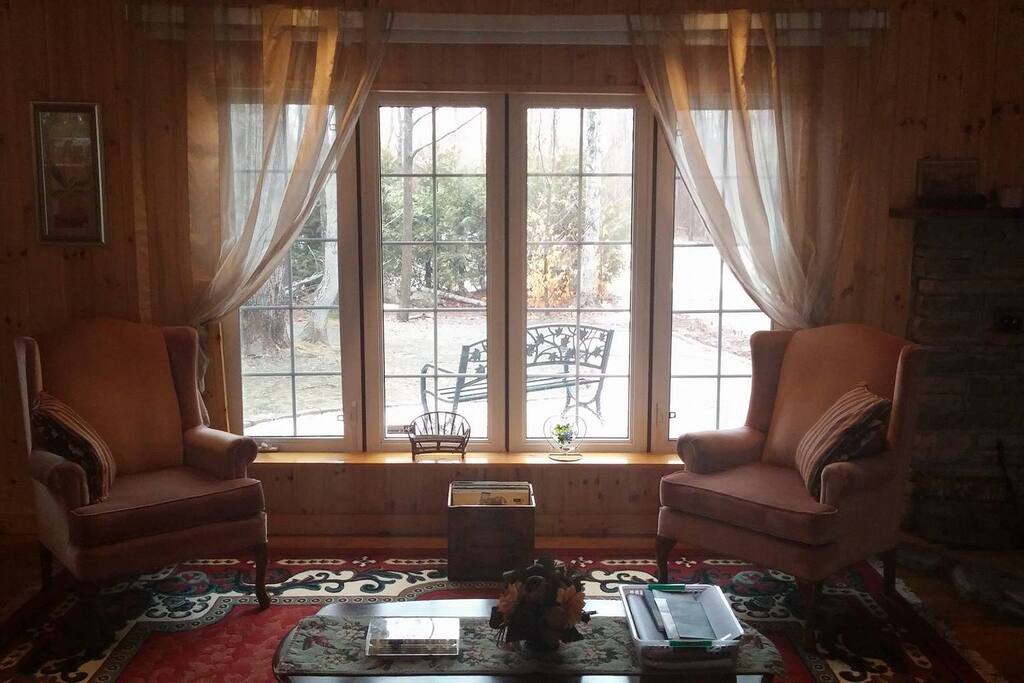 Lower living room with wood stove and futon.