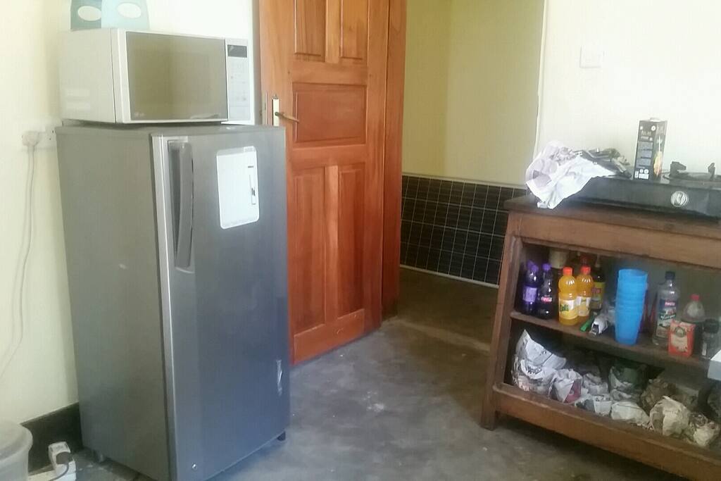 Kitchen with a fridge, gas cooker and microwave oven
