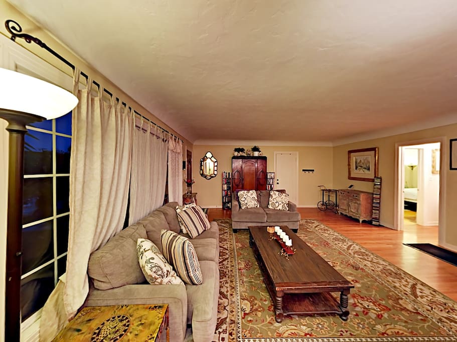 The spacious living room offers original 1920s charm paired with modern updates.