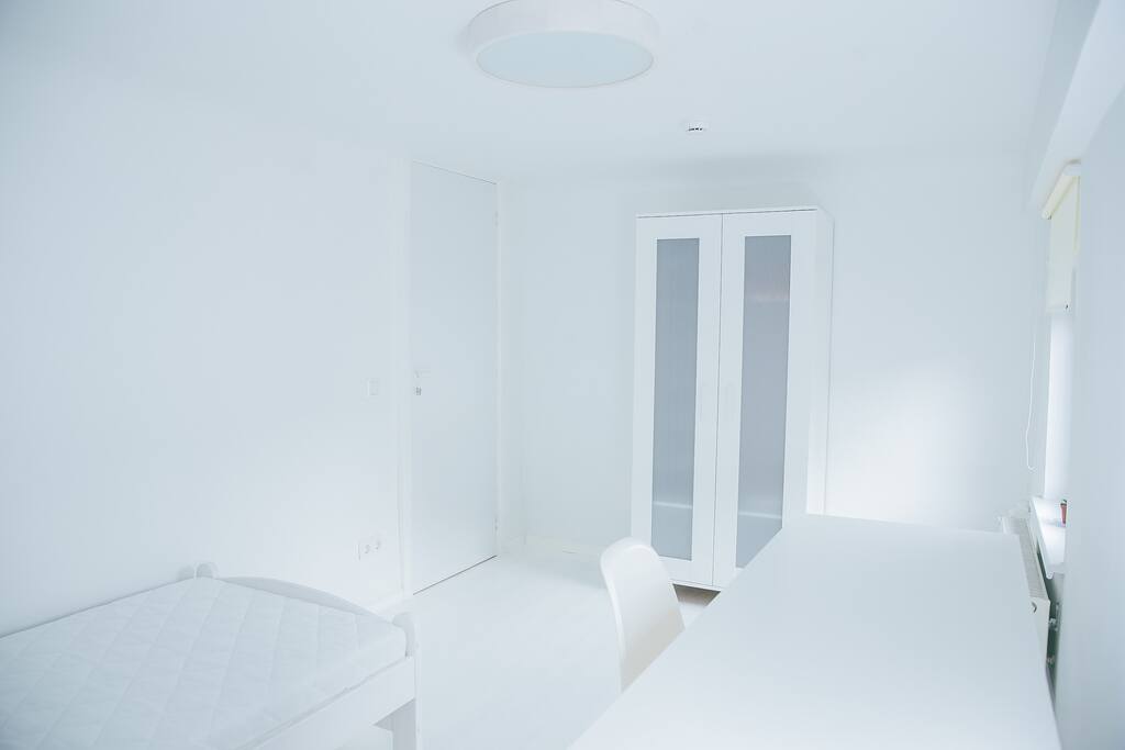 Bedroom 7 with single bed, wardrobe, desk and chair.