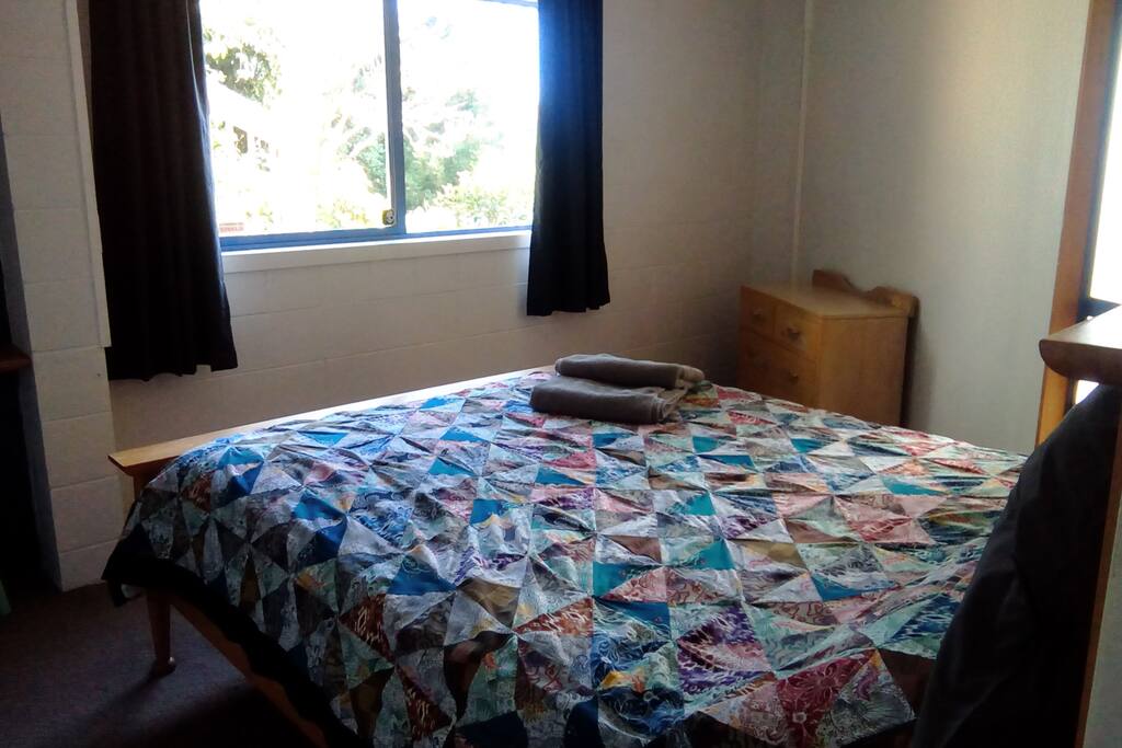 Cosy queen bed with views to the sea.