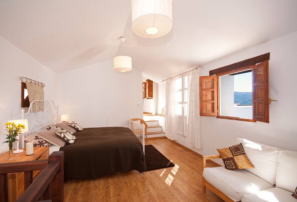 Upstairs bedroom with steps up to en suite bathroom