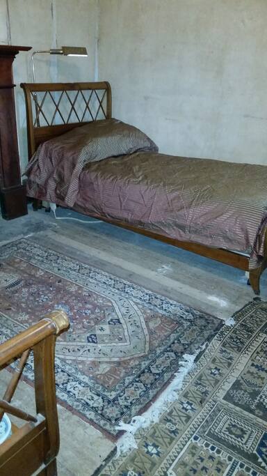 Bedroom with two cherry-wood framed electric beds.