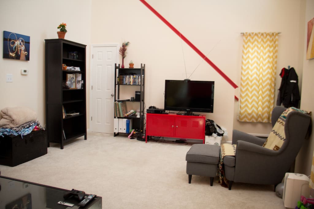 Open living room with TV. Option for Google Chromecast over guest wifi.