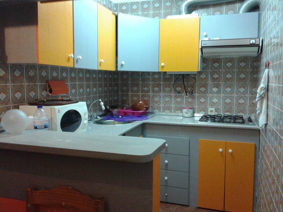 Kitchen (Equiped w/ stove, oven, microwave, fridge, washing machine - clothes only, and an old coffee machine which may prove difficult to get to work properly)