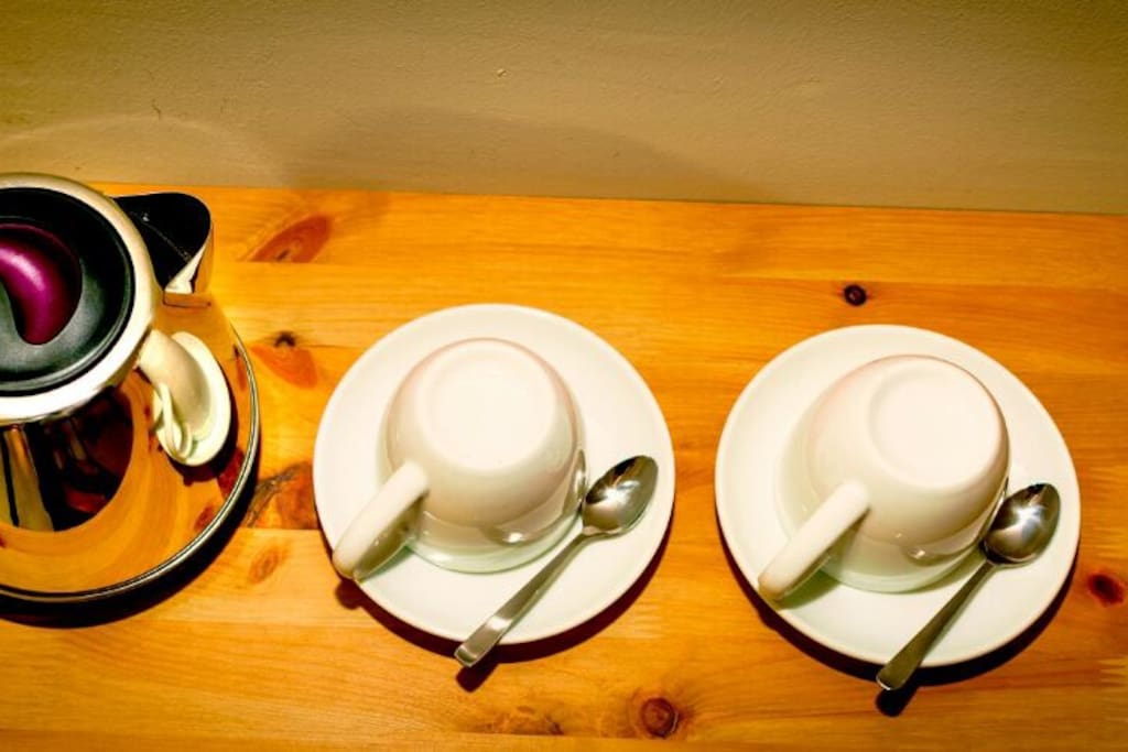 An electric kettle, cups, saucers and teaspoons provided in all rooms