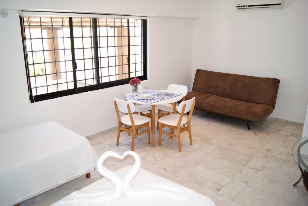 Master bedroom with dining area and sleeper sofa
