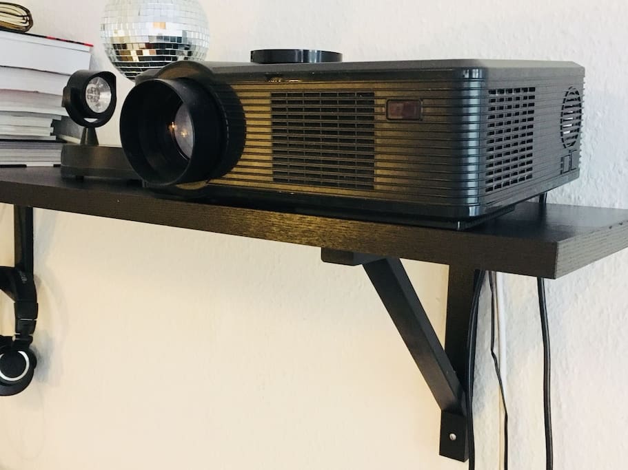 This is one of those hidden jewels. Take a look on your left and up: Yes, you can connect the projector to your laptop and enjoy a movie :)