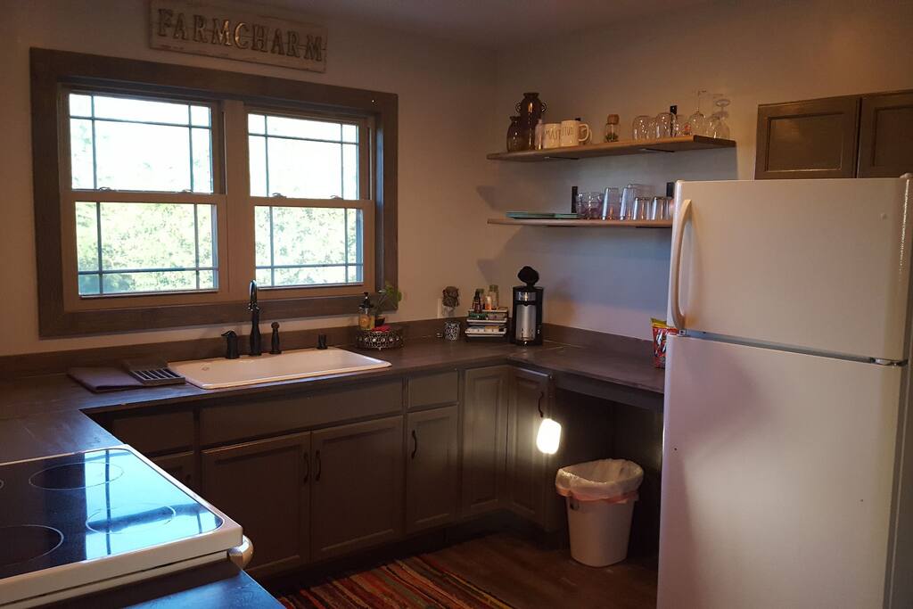 Kitchen with full refrigerator and stove.