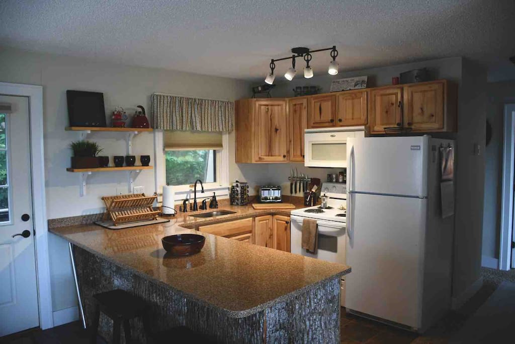 Full kitchen with island wrapped in tree bark design.