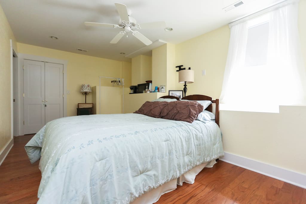 Master Bedroom - comfy queen bed, rocking chair, coffee maker, microwave, dresser, clothes rack, iron, ironing board