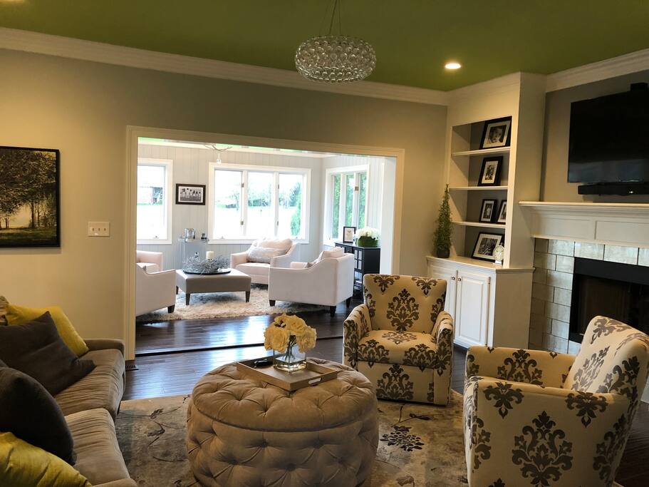 Family room with fireplace is open to kitchen and sunroom