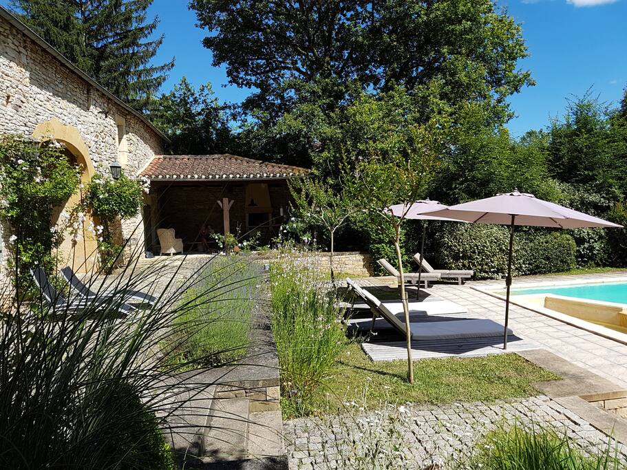 Sunbeds and covered summer kitchen with barbeque