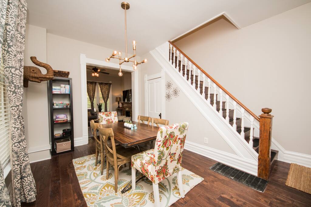 Cool Dining Room with industrial wood table and updated modern fixture.