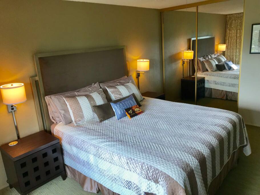Comfy king size bed full of pillows and chocolates!