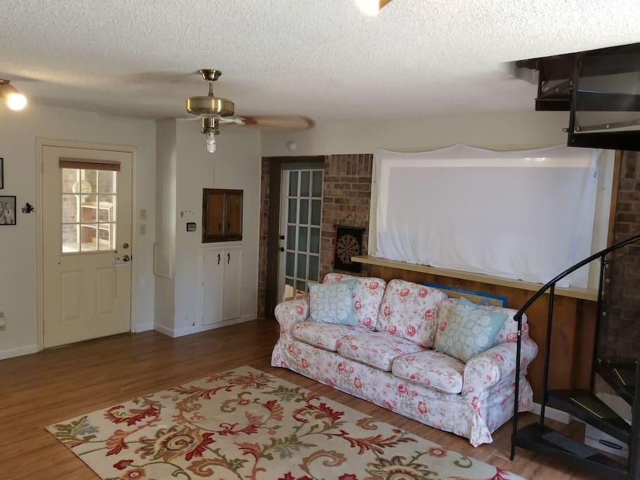 Room #1, Downstairs showing couch, common door to Main house which is double locked, and private entrance.