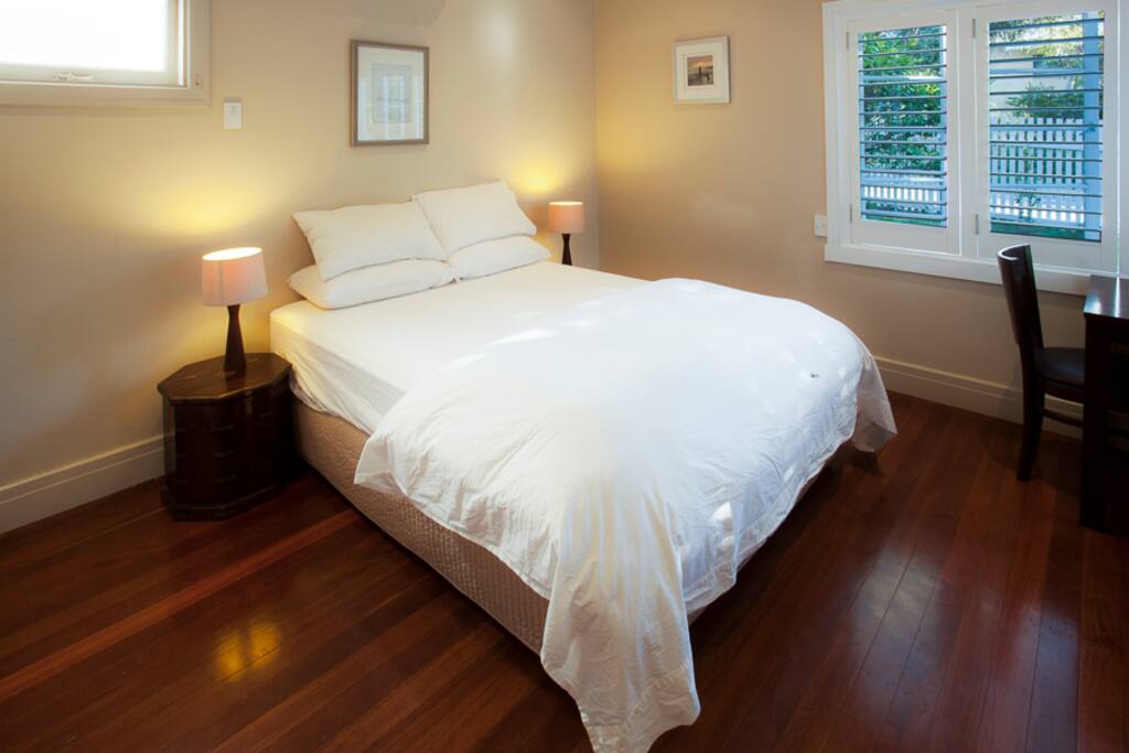 Bedroom 1 with desk and lamp. Build in robes.