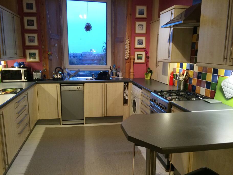 Large rear facing dining kitchen with breakfast bar and separate dining area. Views towards the Firth of Forth