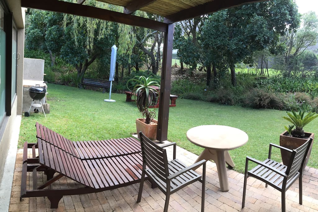 Patio with filtered shade, table, chairs & loungers
