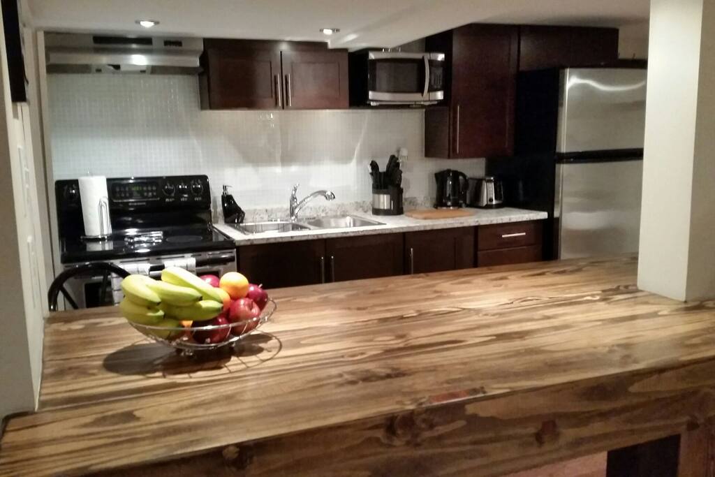 Kitchen & custom built wood island with bar stools.